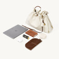 Cream leather Small Gather Bag Set shown with an iPad, AirPods, lipstick, notebook, and glasses case to illustrate capacity.