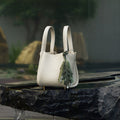 Morning Dew in Paris handbag in forest green with pebble-grain leather, styled with a leaf charm.
