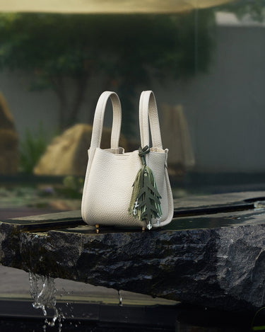 Morning Dew in Paris handbag in forest green with pebble-grain leather, styled with a leaf charm.