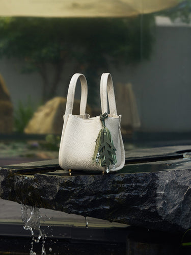 Morning Dew in Paris handbag in forest green with pebble-grain leather, styled with a leaf charm.