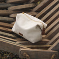 Songmont canvas storage bag with leather accent and gold zipper