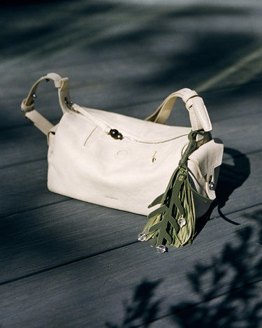 Morning Dew in Paris charm in Forest green leather with leaf design and beads.