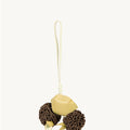 Light yellow leather crab charm with brown pom-poms and leaf accents