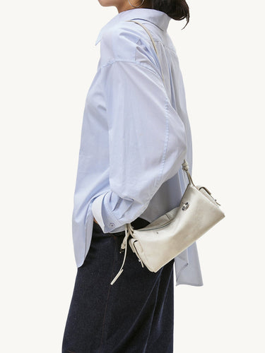 Mini Yore Camera Bag in cloud color made from vegetable-tanned leather with silver hardware.