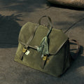 Songmont Morning Dew in Paris charm in forest green full-grain leather with gold hardware.