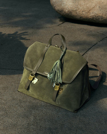 Songmont Morning Dew in Paris charm in forest green full-grain leather with gold hardware.