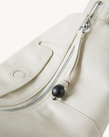 Mini Yore Camera Bag in Cloud color, featuring vegetable-tanned leather, silver zipper, and ebony wood detail.