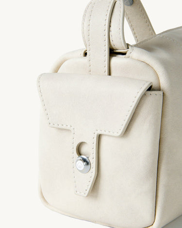 Mini Yore Camera Bag in Cloud color, crafted from vegetable-tanned leather with a classic flap and button closure.