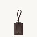 Brown leather Songmont luggage tag with strap and clear card slot.