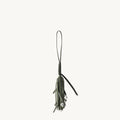 Forest green leather tassel charm for bags with clear beads, featuring embossed Songmont logo.