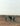 Person standing next to a donkey on a desert landscape