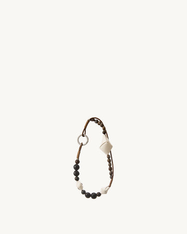 Small Carefree Thread Charm in Sandal, featuring alternating sandalwood and soapberry seeds with woven leather diamonds.