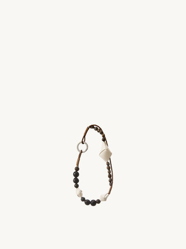 Small Carefree Thread Charm in Sandal, featuring alternating sandalwood and soapberry seeds with woven leather diamonds.