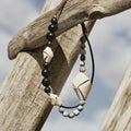 Small Carefree Thread Charm in Sandal with dark wood, stone, and leather charms