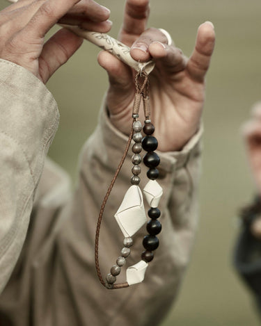 Small Carefree Thread Charm in Sandal color with wooden and leather beads.