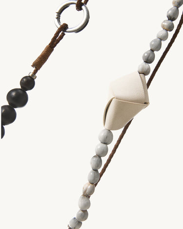 Small Carefree Thread Charm in Sandal with bodhi seeds, sandalwood beads, and leather diamond. Features metallic clasp.