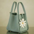 Light blue leather daisy charm handbag with white daisy decoration