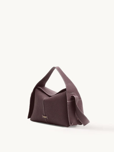 Drippy Roof Bag in burgundy full-grain leather with white stitching and gold logo.