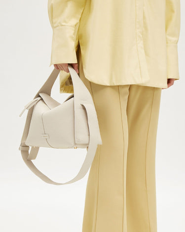 Drippy Roof Bag in cream full-grain leather with adjustable strap and SS hardware.