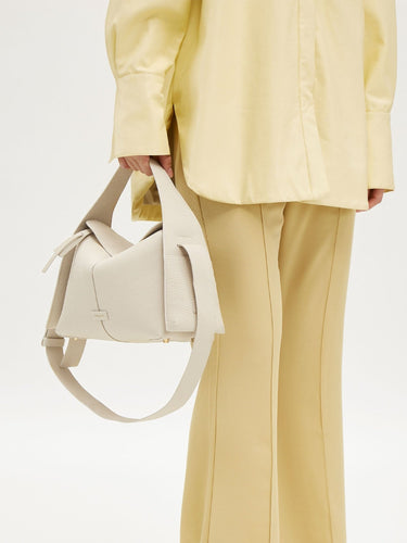 Drippy Roof Bag in cream full-grain leather with adjustable strap and SS hardware.