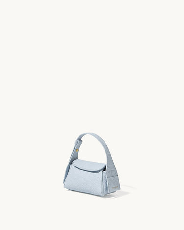 Light blue pebbled leather Mini Drippy AirPods Case with a short handle and a snap closure.