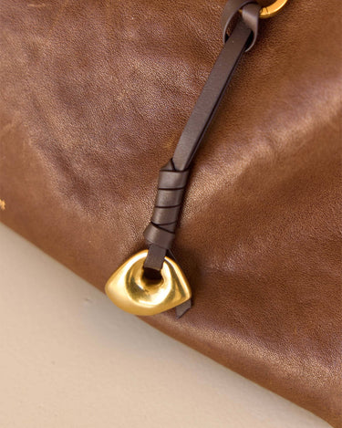 Faith Stone Charm in brown vegetable-tanned leather with golden hardware