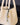 Faith Stone & Prayer Wheel Charm Set: Sandal textured leather tote with gold hardware charm detail.