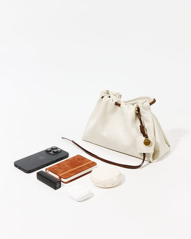 Cloud Gather Clutch Set with iPhone, power bank, earbuds, and compact