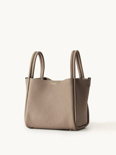 Songmont large leather bucket bag in taupe with double top handles and a minimalist design.
