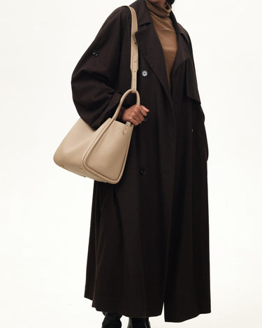 Large Song Bag in Cream Apricot, pebbled leather with adjustable strap and gold hardware.