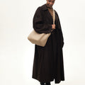 Large Song Bag in cream apricot, textured leather bucket bag with gold hardware and adjustable strap.