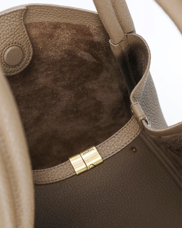 Large Songmont bag in taupe leather. Close-up of interior with suede lining and gold clasp.