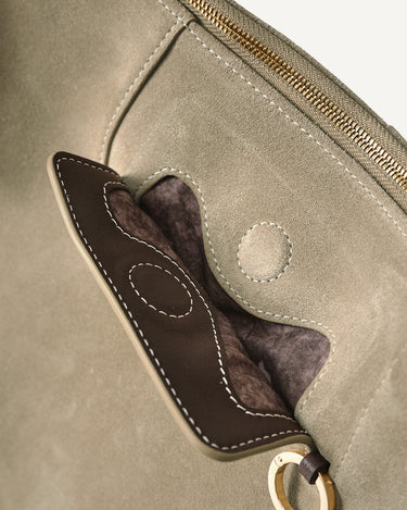 Close-up of Large Yore Hobo Bag in Dune Suede, showing stitching detail and gold hardware.