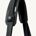 Close-up of the black leather strap and closure mechanism on the Large Yore Tote Bag, showcasing the pebbled texture and stainless steel hardware.