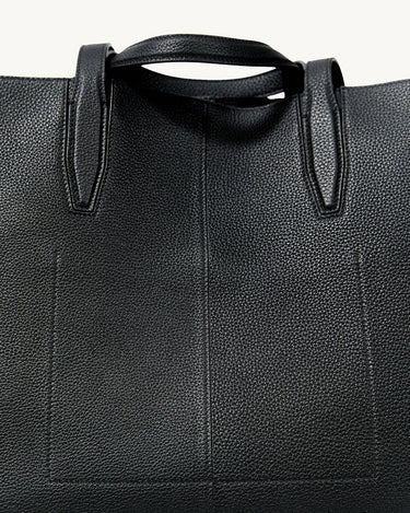 Onyx black full-grain leather Large Yore Tote Bag detail: pebbled texture and stitching.