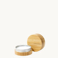 Leather care balm in bamboo container with lid to the side