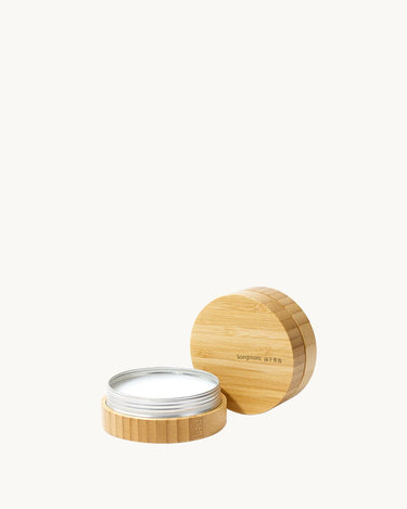Leather care balm in bamboo container with lid to the side