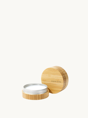 Leather care balm in bamboo container with lid to the side