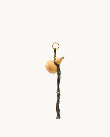 Lucky Gourd Charm in Cypress: natural gourd, braided cord, gold keyring. Symbol of luck and wealth.