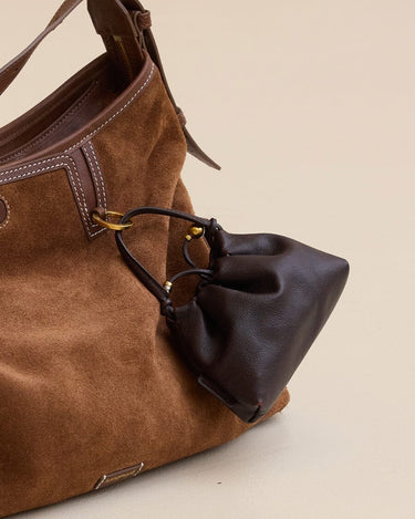 Lucky Pouch Charm: Brown suede shoulder bag with dark brown leather pouch, adjustable strap.