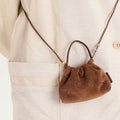 Brown suede Lucky Pouch Charm with drawstring, cow suede leather, 11cm dimensions, on adjustable strap.