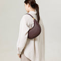 Burgundy Luna Bag, pebble-grain leather crossbody bag with adjustable strap.