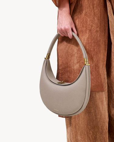 Luna Bag in Cobble, textured full-grain leather handbag with gold hardware and magnetic closure.