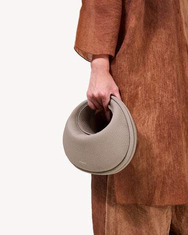 Luna Bag in Cobble textured leather, a crescent-shaped crossbody bag with a supple feel, perfect for everyday use.