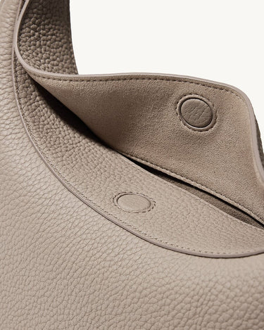 Close-up of the textured leather Luna Bag in Cobble color, showing the magnetic closure detail.