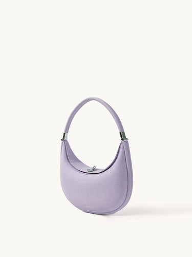 Lavender full-grain leather Luna Bag with silver hardware, crescent shape and adjustable strap.