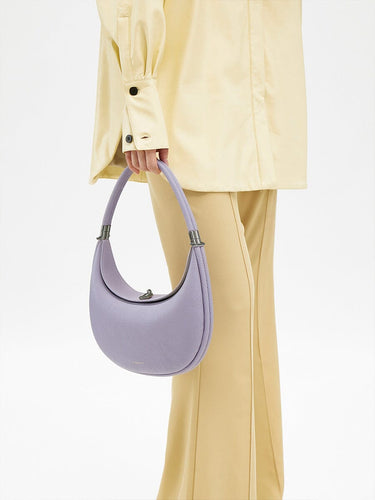 Light purple full-grain leather Luna Bag with SS 304 hardware, held by a hand.