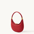 Lucky Red Luna Bag crafted from textured full-grain leather with gold hardware and a magnetic clasp.