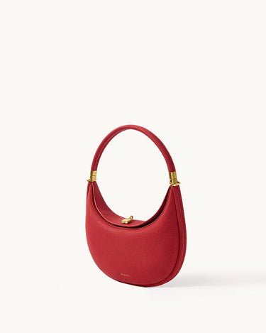 Lucky Red Luna Bag crafted from textured full-grain leather with gold hardware and a magnetic clasp.