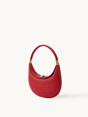 Lucky Red Luna Bag crafted from textured full-grain leather with gold hardware and a magnetic clasp.